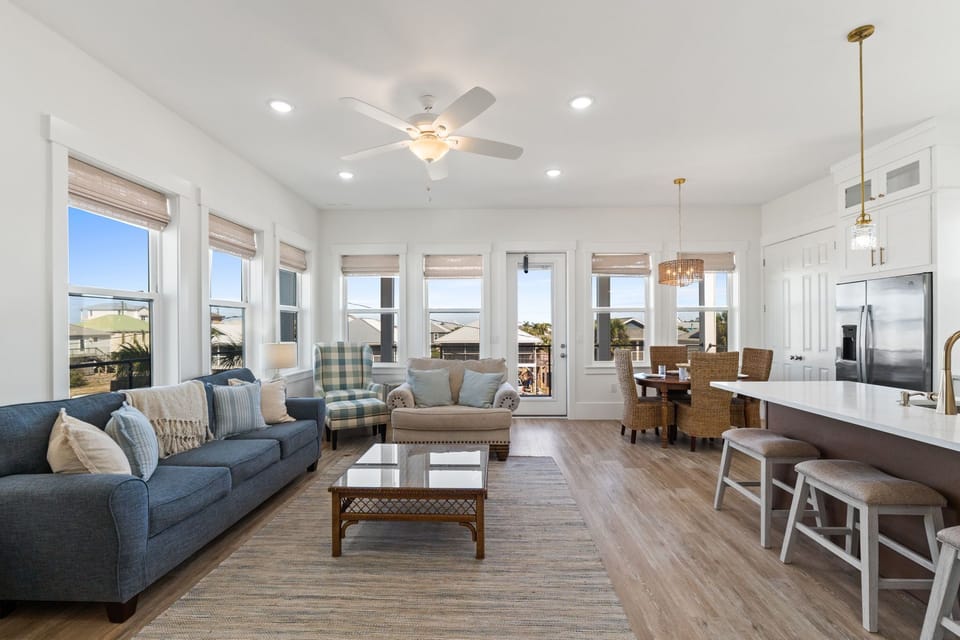 Relax in your bright, open living space where coastal charm meets modern comfort with panoramic windows and thoughtful touches throughout.