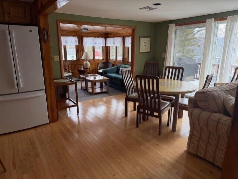 You'll love this open-concept living space where your family can gather around the dining table while someone prepares meals in the modern kitchen.