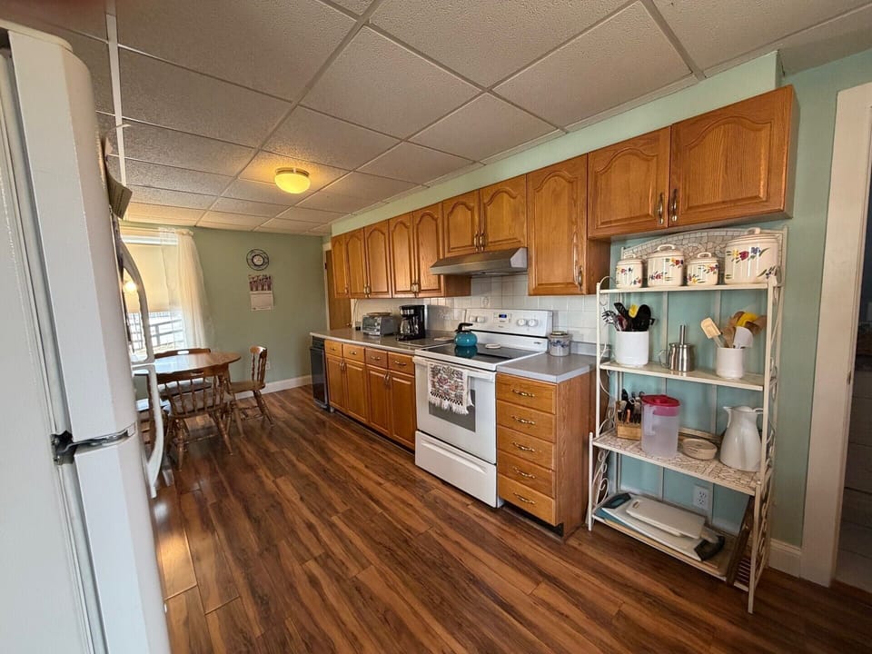 Your fully equipped kitchen features warm wood cabinets, modern appliances, and plenty of space to create memorable meals during your stay.