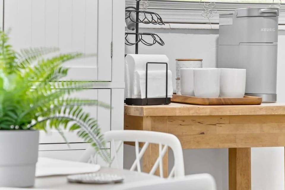 Comfortable dining table for four, ideal for meals, work, or planning your day.