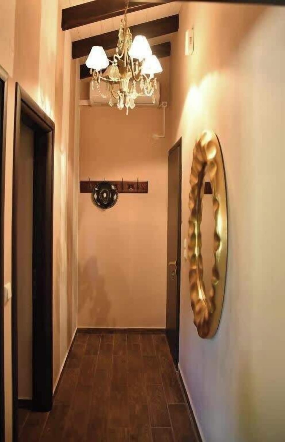 Warm and welcoming hallway with elegant lighting and stylish decorative touches