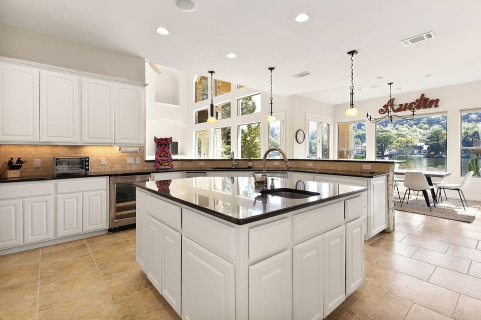 Chef's kitchen island opens toward the Lake Austin dining views