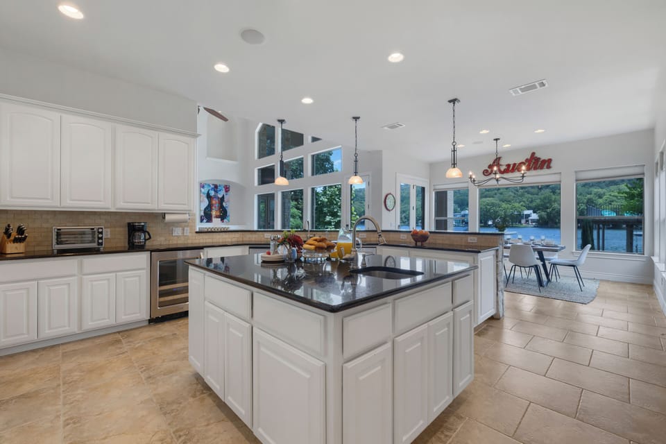 Granite island kitchen flowing into the lake view dining