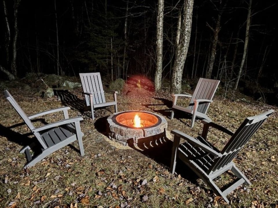 Backyard fire pit with Adirondack chairs