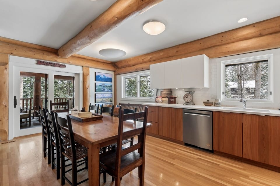 Gather around your spacious dining table where exposed beams create rustic charm while modern appliances make meal prep a breeze.