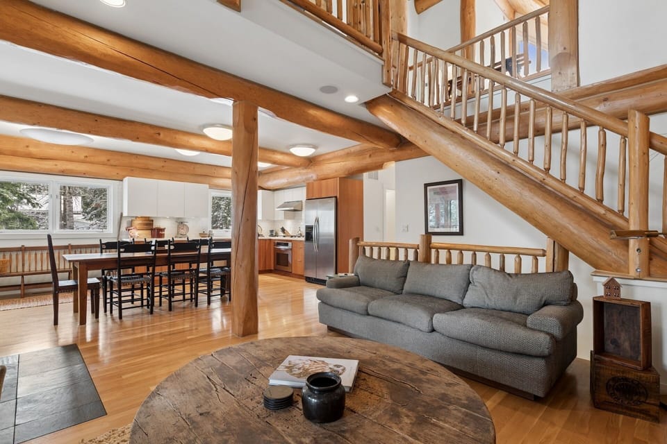 Your rustic open-plan retreat features exposed wooden beams and a cozy living area perfect for unwinding after mountain adventures.