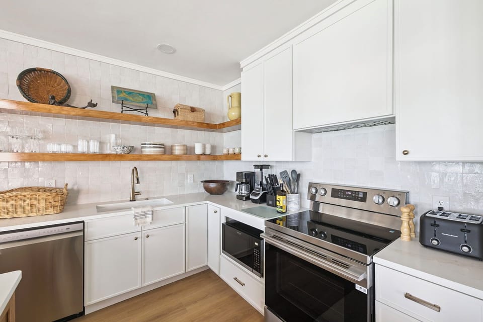 Your fully-equipped kitchen awaits with quality appliances, open shelving, and everything you need to create memorable meals during your stay.