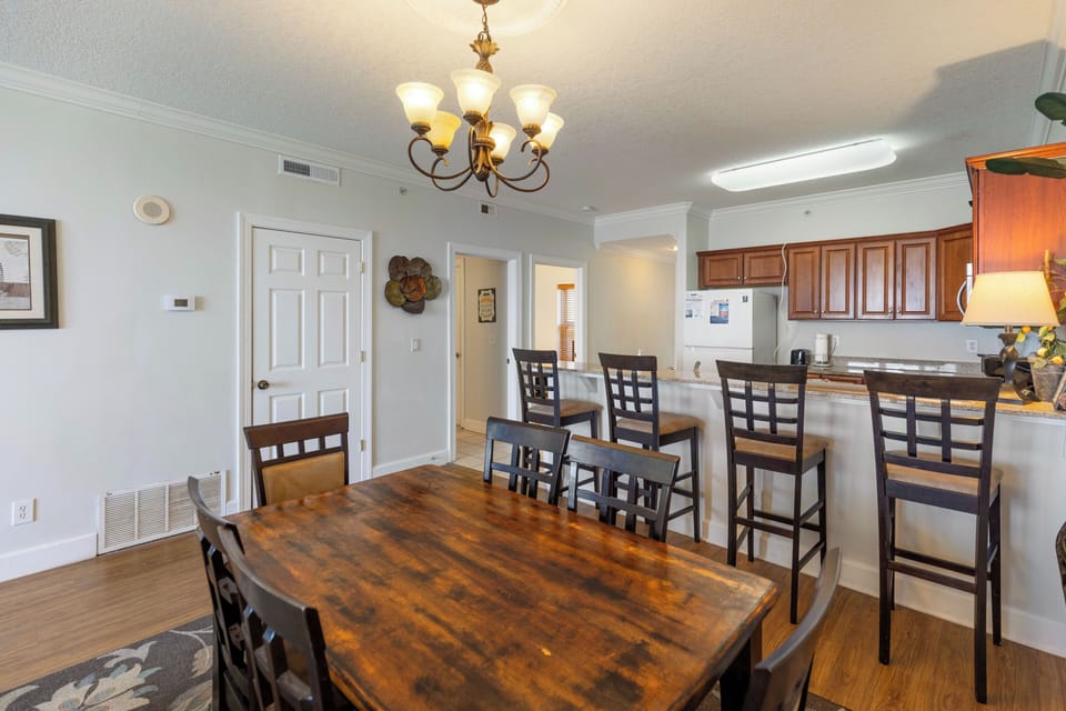 Gather around the rustic wooden dining table for memorable meals with your group, then enjoy casual conversations at the kitchen bar.