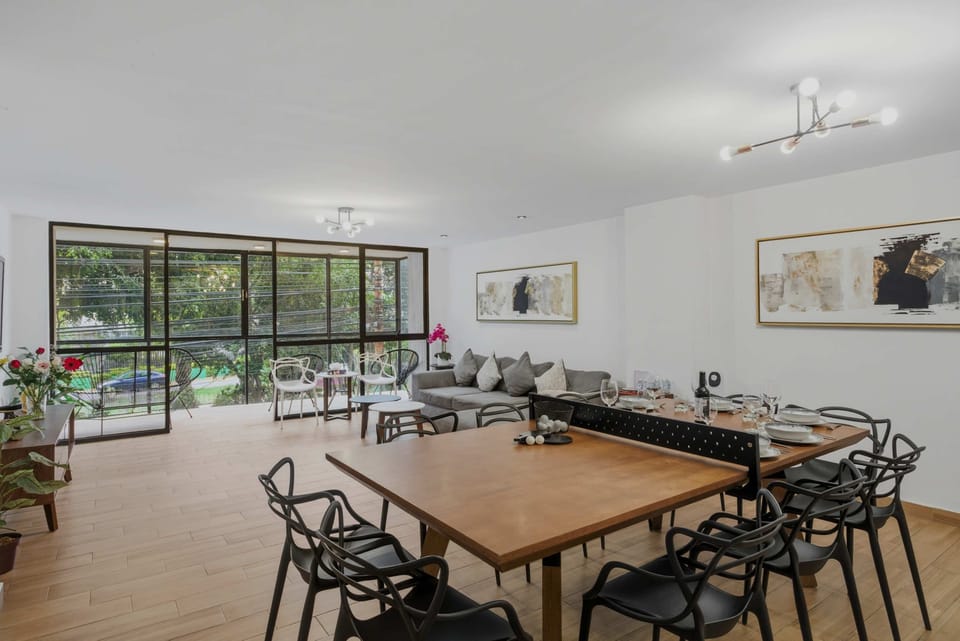Bright living room, balcony, floor-to-ceiling windows and dining room.