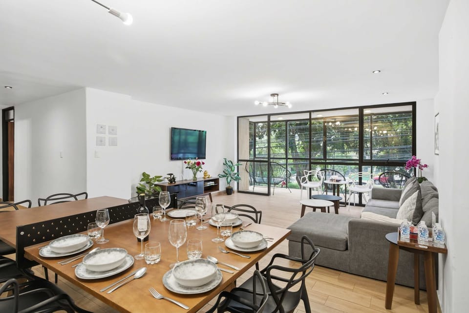 Open concept dining area with a table that converts into a ping pong table and a spacious adjoining living room