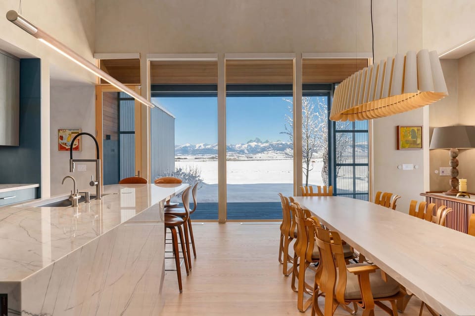 A kitchen and dining setup built for groups, with mountain views stretching across the valley right from the table.