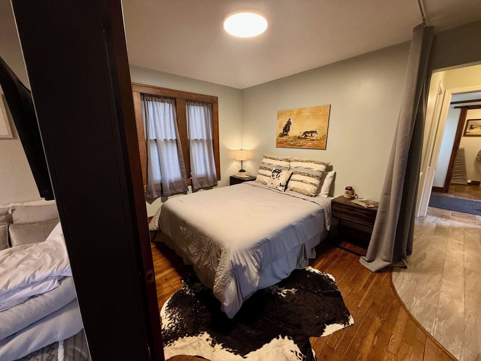 Queen bedroom with privacy curtains.