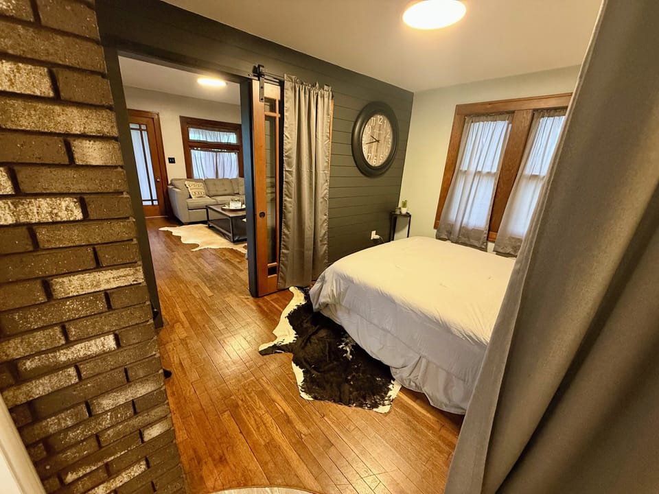 Queen bedroom with privacy curtains.