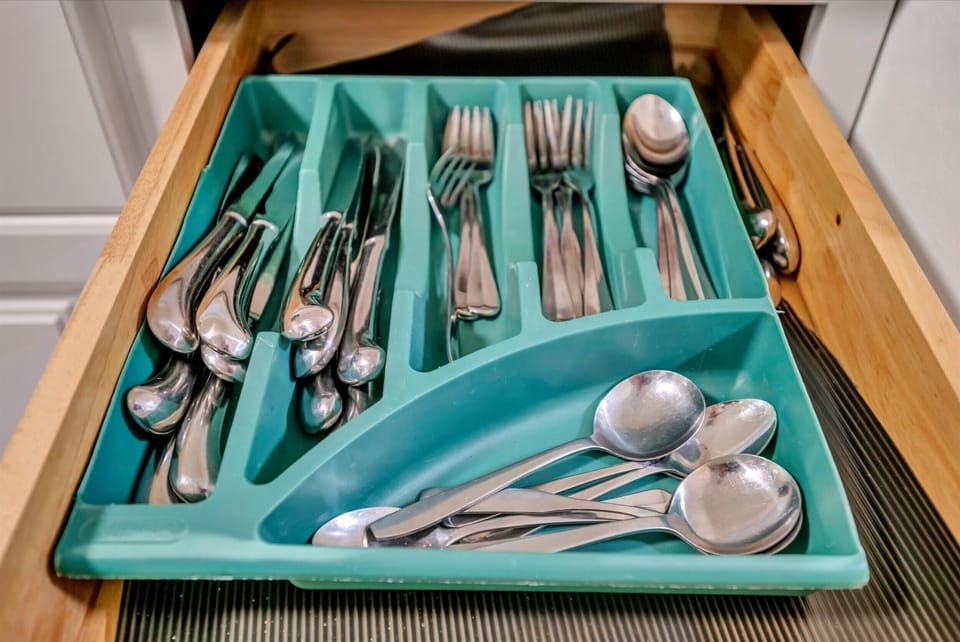 Complete cutlery set with spoons, forks, and tools