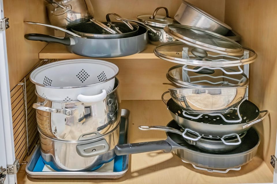 Cookware cabinet with pots, pans, and lids