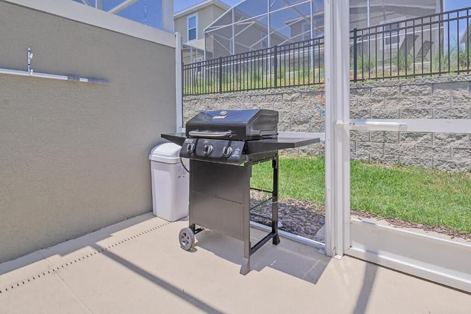 BBQ grill on screened patio for outdoor cooking