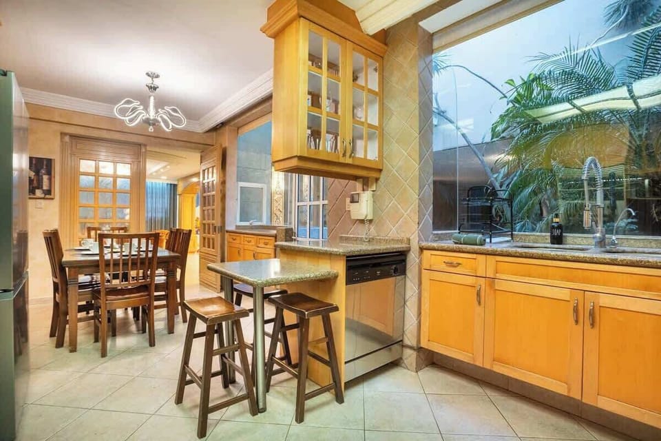 A generous kitchen setup with table and breakfast bar.
