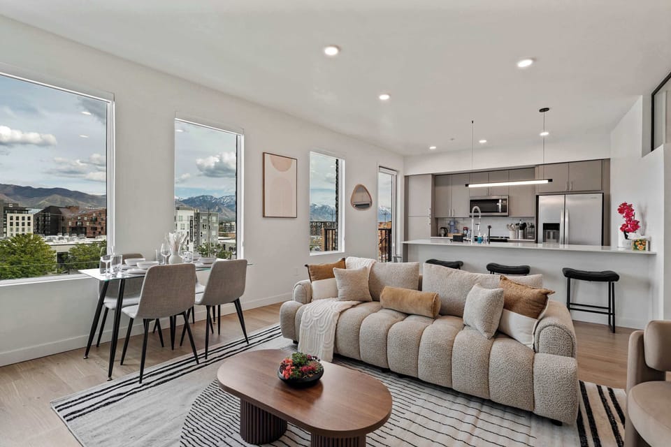 Open concept living and dining space with mountain views, cozy seating, and modern design, perfect for relaxing and gathering