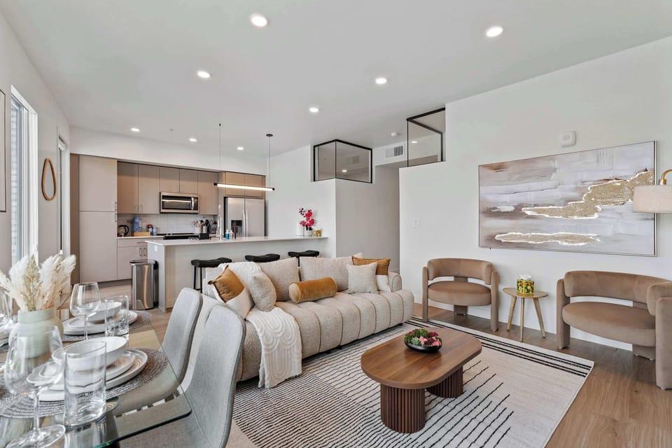 Cozy living space with designer touches and large windows, perfect for comfort and natural light