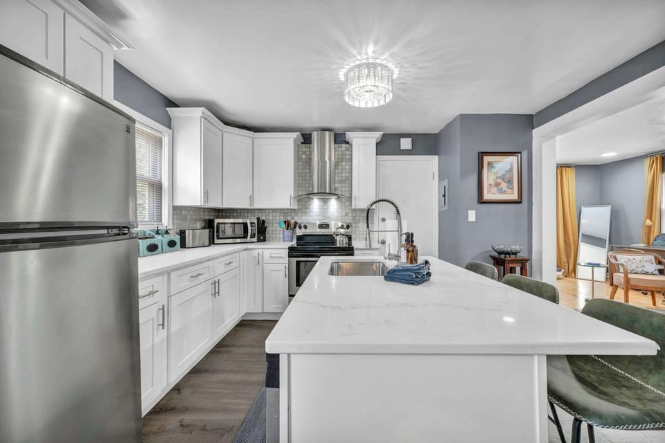 Kitchen w/ island, stainless steel sink & plenty of counter space to prep your favorite meals.
