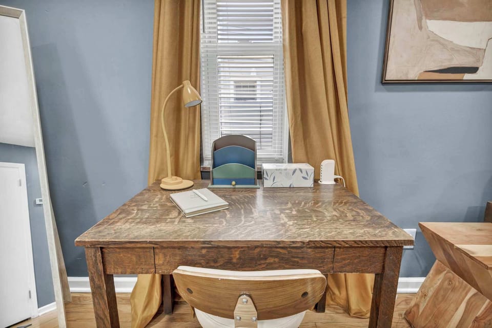 Bright workspace w/ a desk by the window — a quiet corner to stay productive during your stay.
