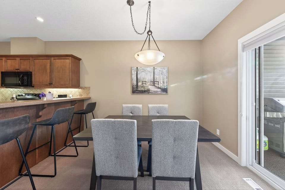 Dining area with seating for 4 at the table and 3 at the island.