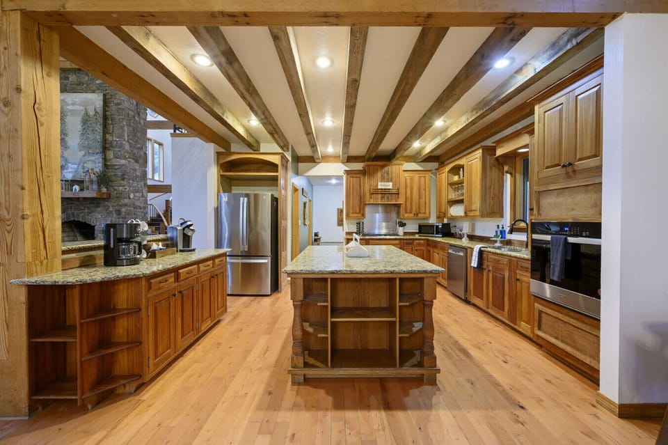 The professional-grade kitchen features high-end appliances and custom wood cabinetry.