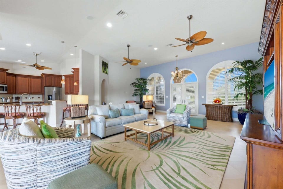 Large open living space overlooking the pool & canal beyond. Living room features lots of seating and 65-inch Smart TV