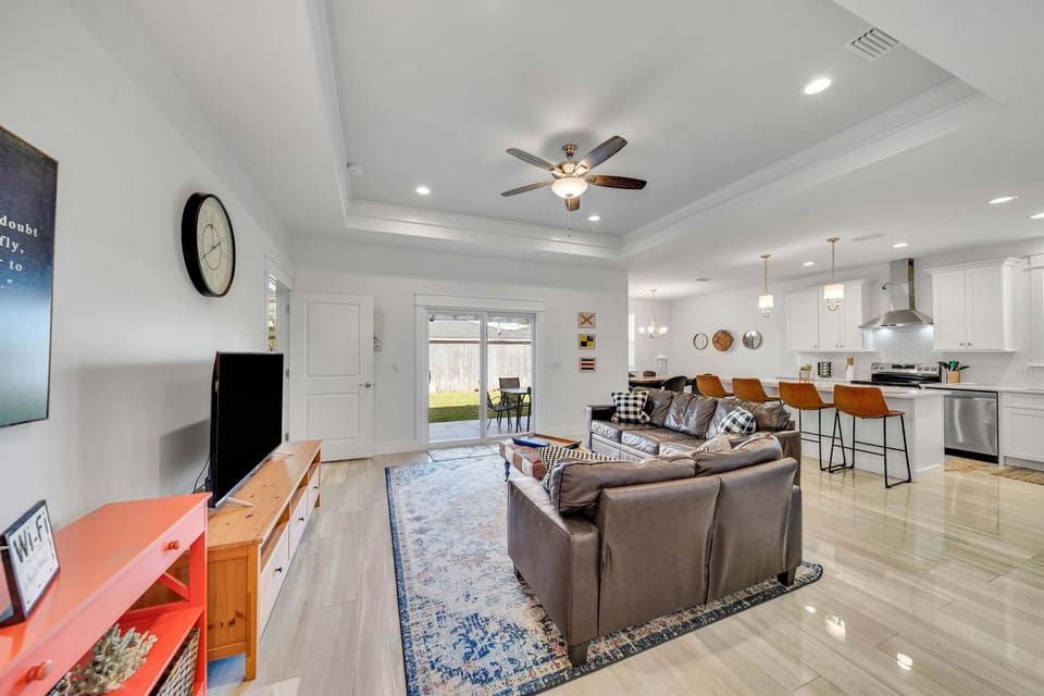 The living room gets lots of natural sunlight. You can step right outside to the patio through the sliding glass doors.
