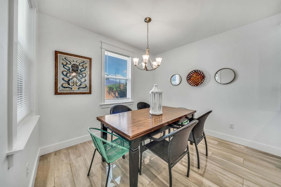 The solid wood dining table comfortably seats six for family meals. The woven chairs provide a relaxing spot to enjoy your morning coffee.
