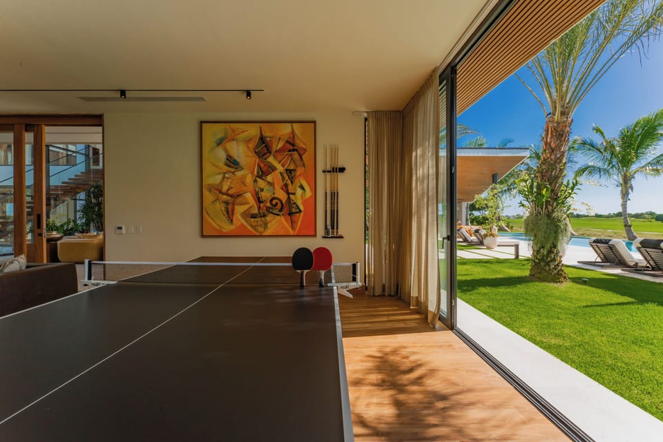 Ping pong table by the patio keeps games bright, open, and connected to the view