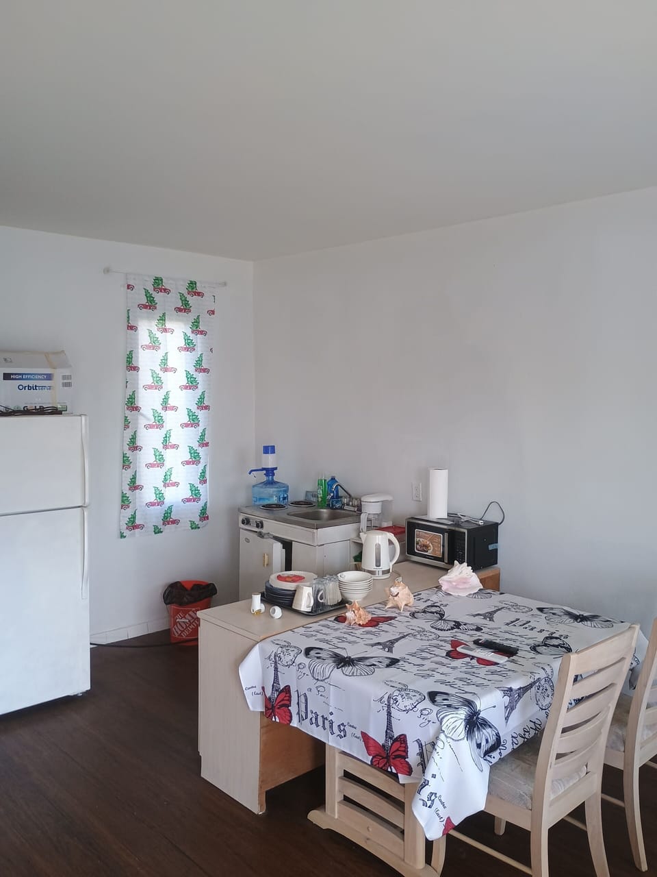 indoor, coffee maker, kitchen, refrigerator, stovetop, dining table, microwave