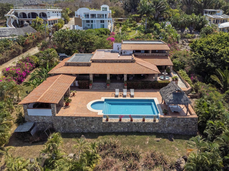 Enjoy a stunning private villa surrounded by lush nature, featuring spacious outdoor areas, a beautiful pool, and the perfect setting for a relaxing getaway.