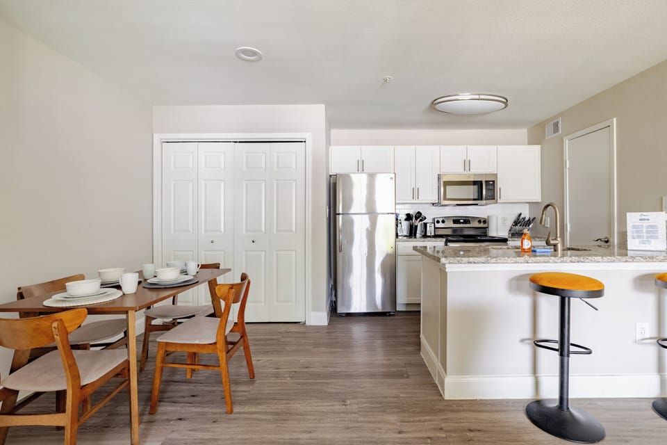 Bright open kitchen and dining area with breakfast bar seating