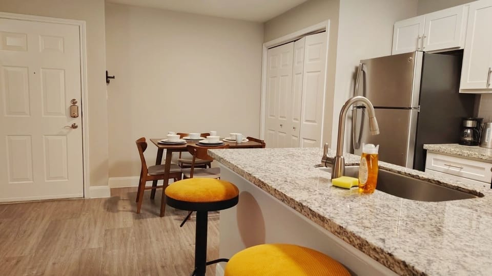 Modern kitchen with granite bar, stainless appliances, and cozy dining nook