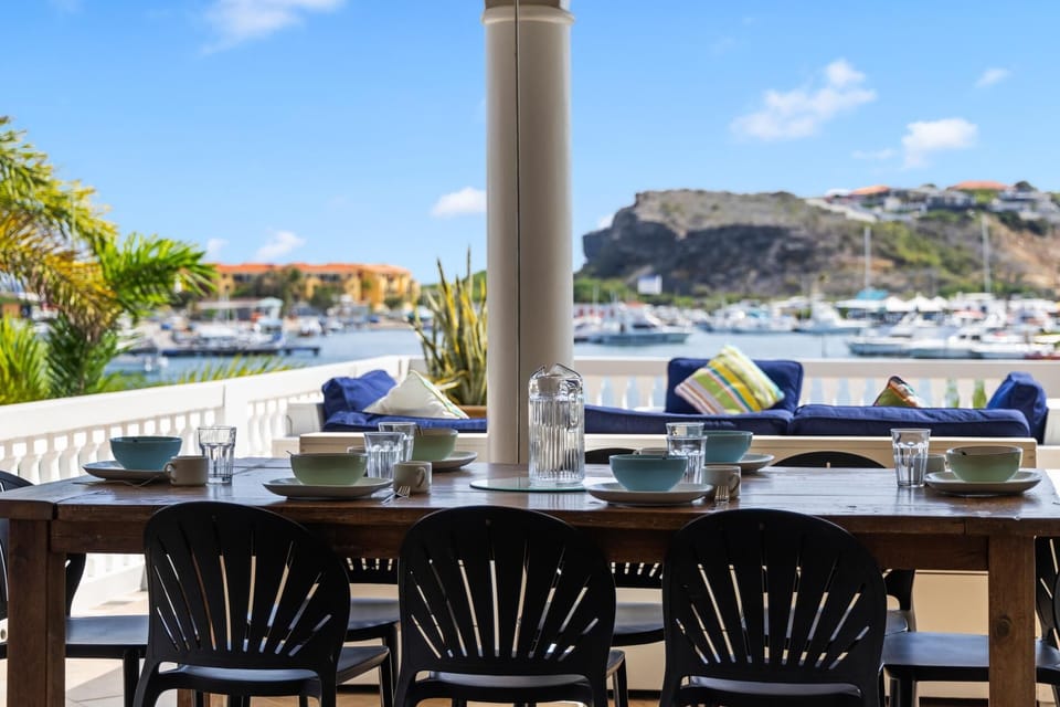 Waterfront dining overlooking Fisherman’s Harbour with boats passing through Spanish Water