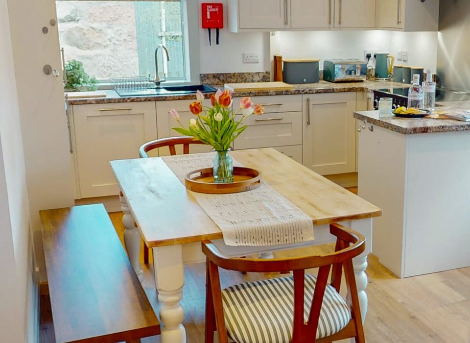 Open kitchen-diner with farmhouse table — perfect for relaxed family dining.