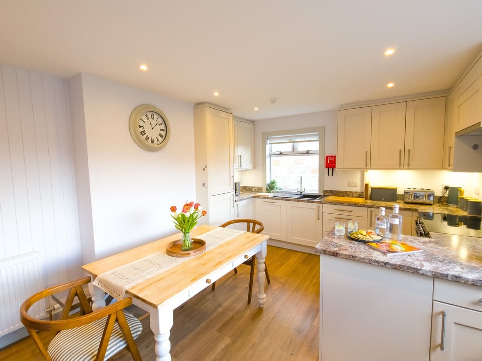 Charming farmhouse dining table  — a lovely spot for meals with the kitchen and Highland countryside close by.