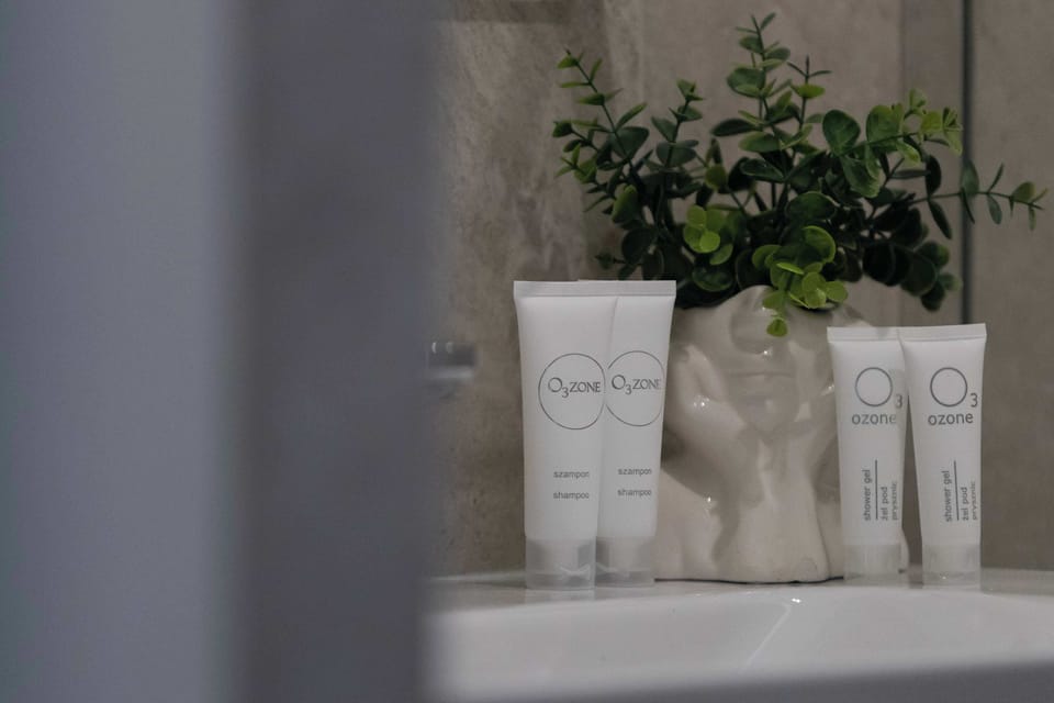 A decorative shelf arrangement with small bottles and a potted plant adding a fresh, natural touch. Soft neutral tones create a calm and minimalist aesthetic.