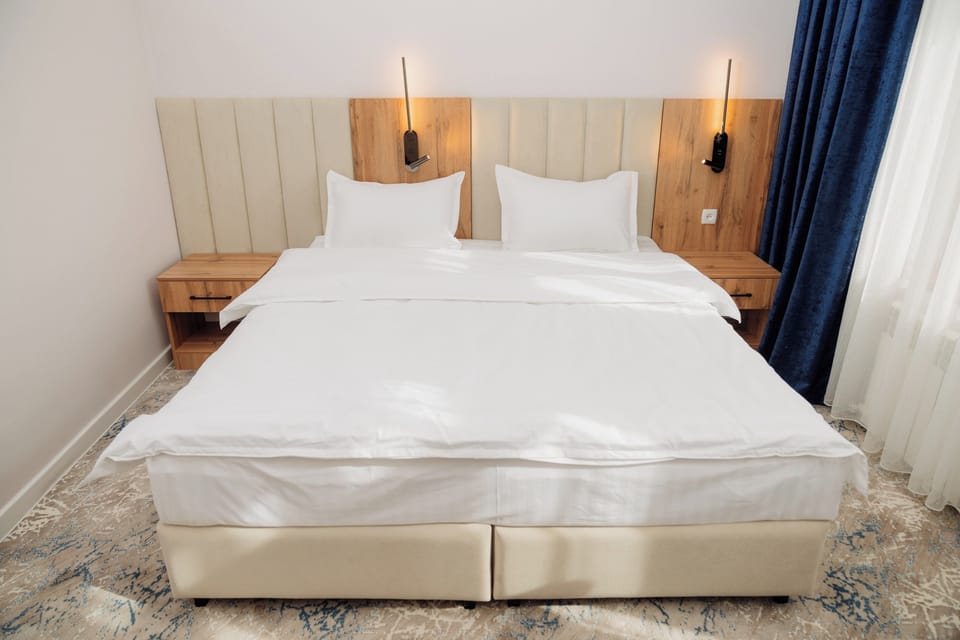 Premium bedding, desk, laptop workspace, blackout drapes