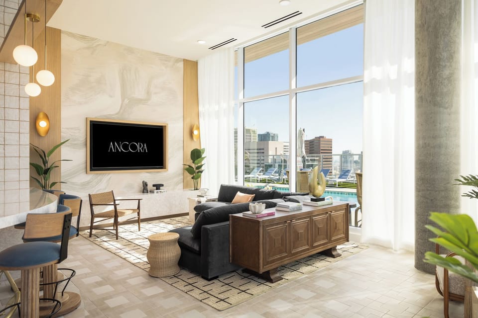Expansive common areas with floor-to-ceiling glass and designer furniture.