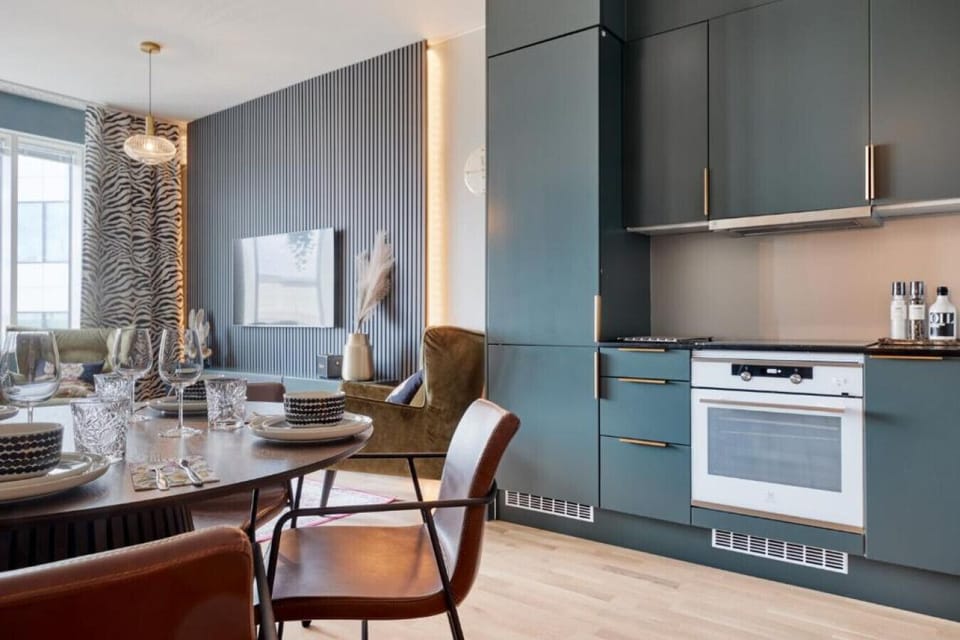 Host a dinner for two at the dedicated dining table, situated right next to a fully equipped kitchen for effortless serving.