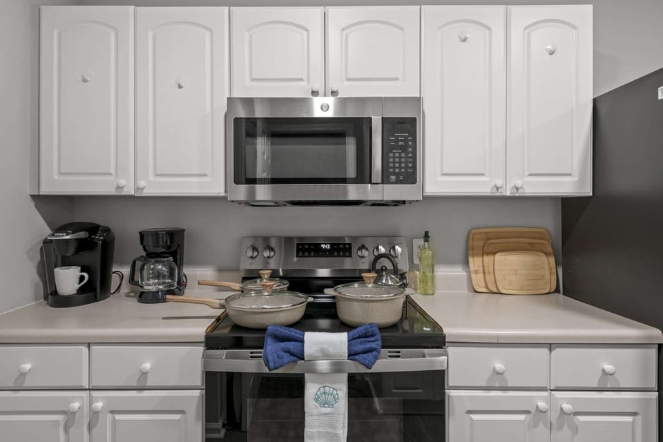 A sleek and functional cooking area featuring a stainless steel stove