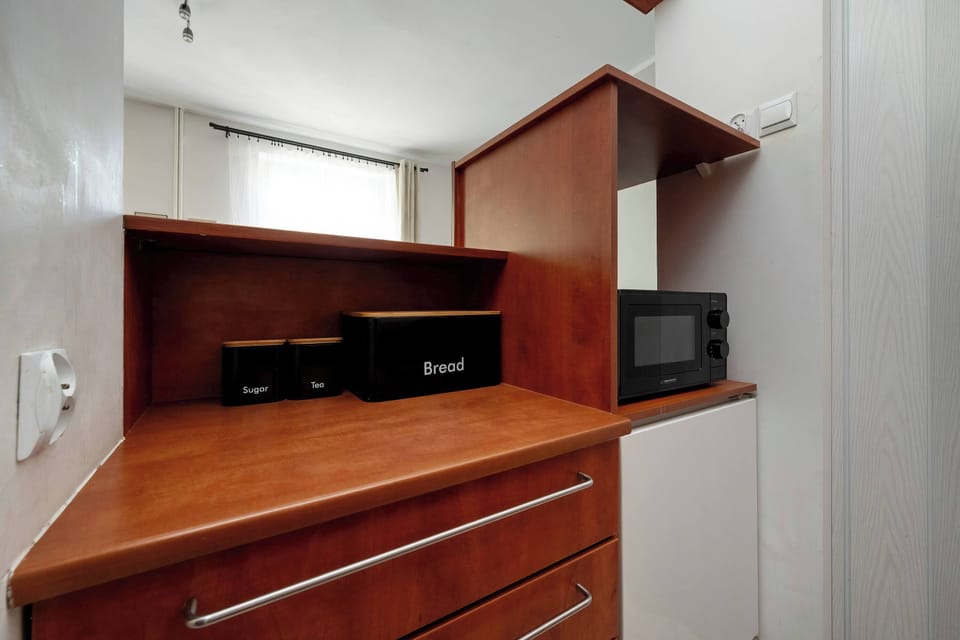 Another kitchen view showing built-in appliances and storage cabinets. The design is efficient and modern.