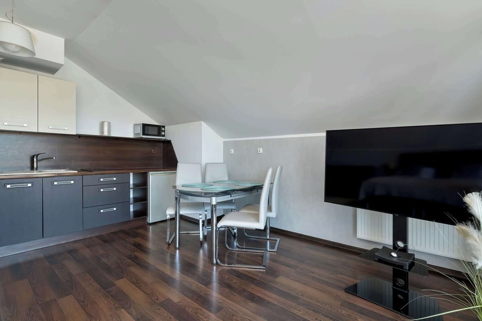 A living and dining space with open layout and modern furnishings. The room is designed for comfort and functionality.