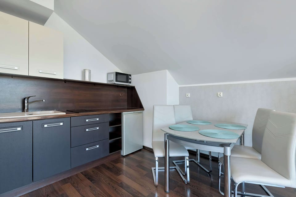 A kitchen and dining area combined in one open space. The layout supports easy cooking and social meals.