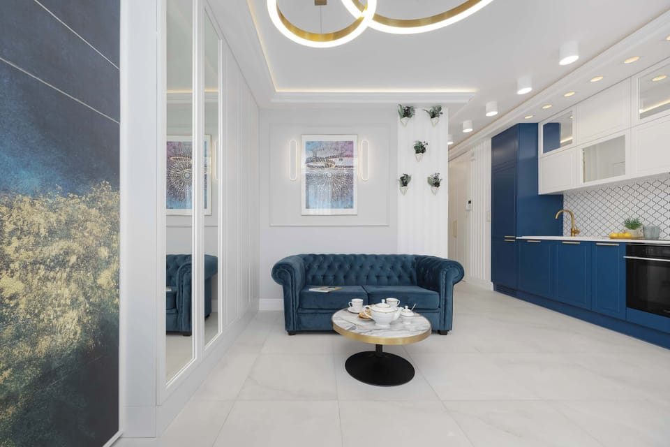 This perspective showcases the entry area where a large wall mural of a forest adds a natural touch to the hallway. The view leads directly toward the bright living room and kitchen at the end of the corridor.