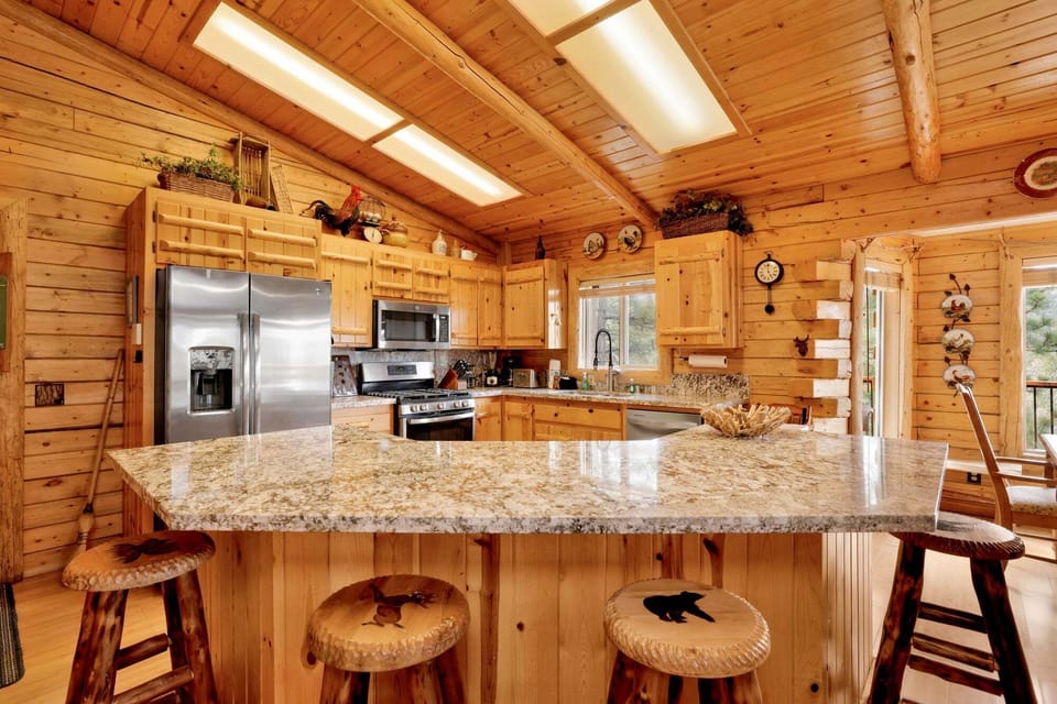 Gorgeous granite island with bar seating and mountain views right out the window. The perfect spot for morning coffee or an after-ski snack with the group.