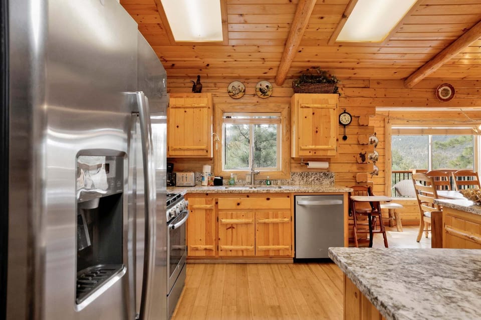 Stainless steel fridge, dishwasher, and full cookware make this kitchen ready for anything from quick breakfasts before the slopes to full group dinners after a long day outdoors.