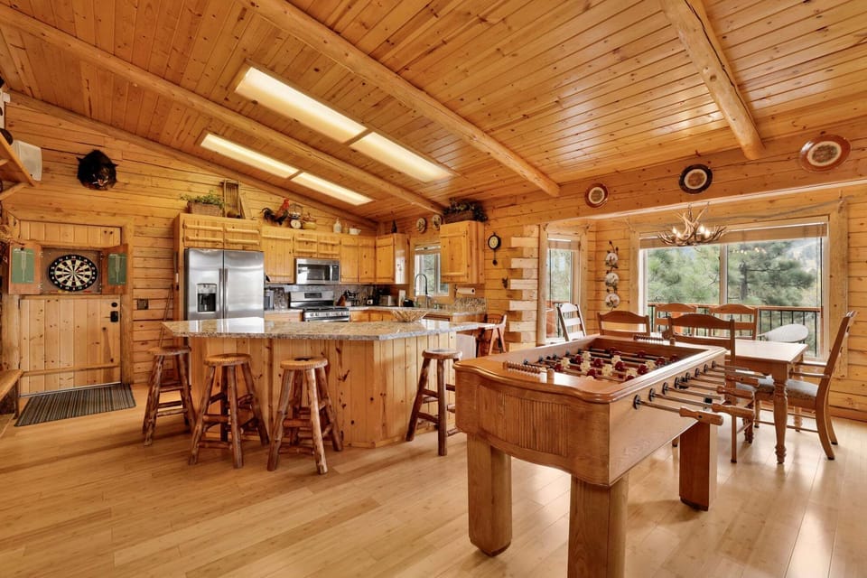 Fully equipped kitchen with bar seating flows into the living area plus a foosball table for friendly competition. Great layout for groups who love to cook, gather, and play.